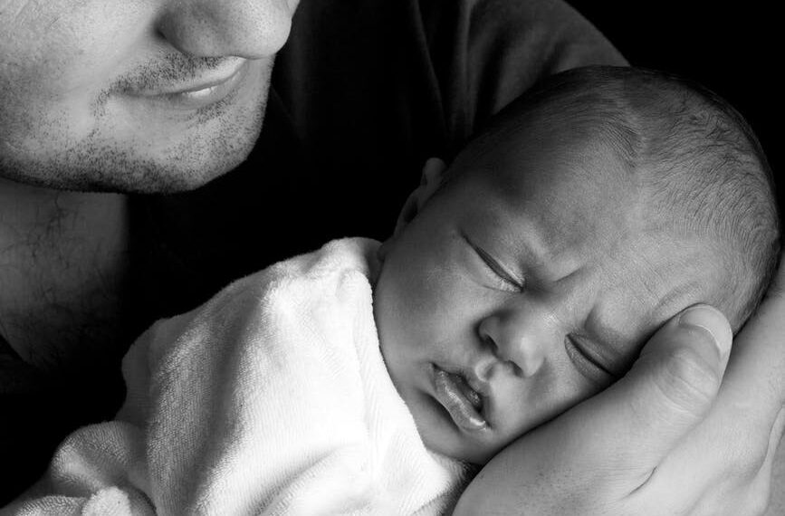 grayscale photo of man holding baby