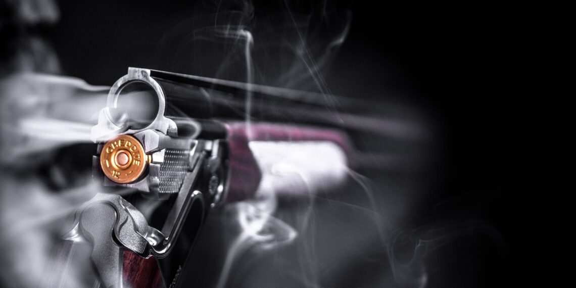 selective focus photo of smoking shotgun