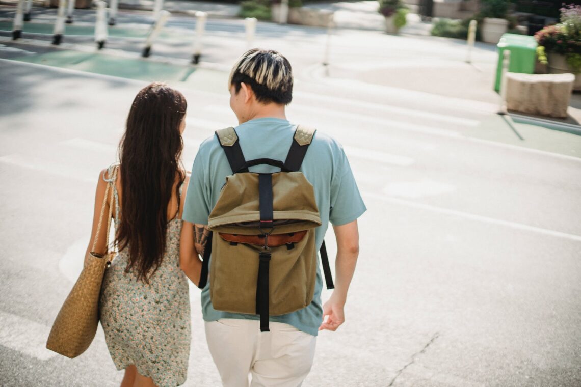 young couple walking together in city district